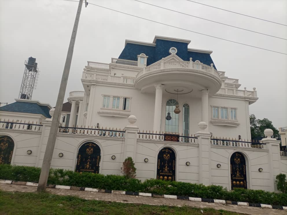 Abuja house with a columned entrance and blue roof